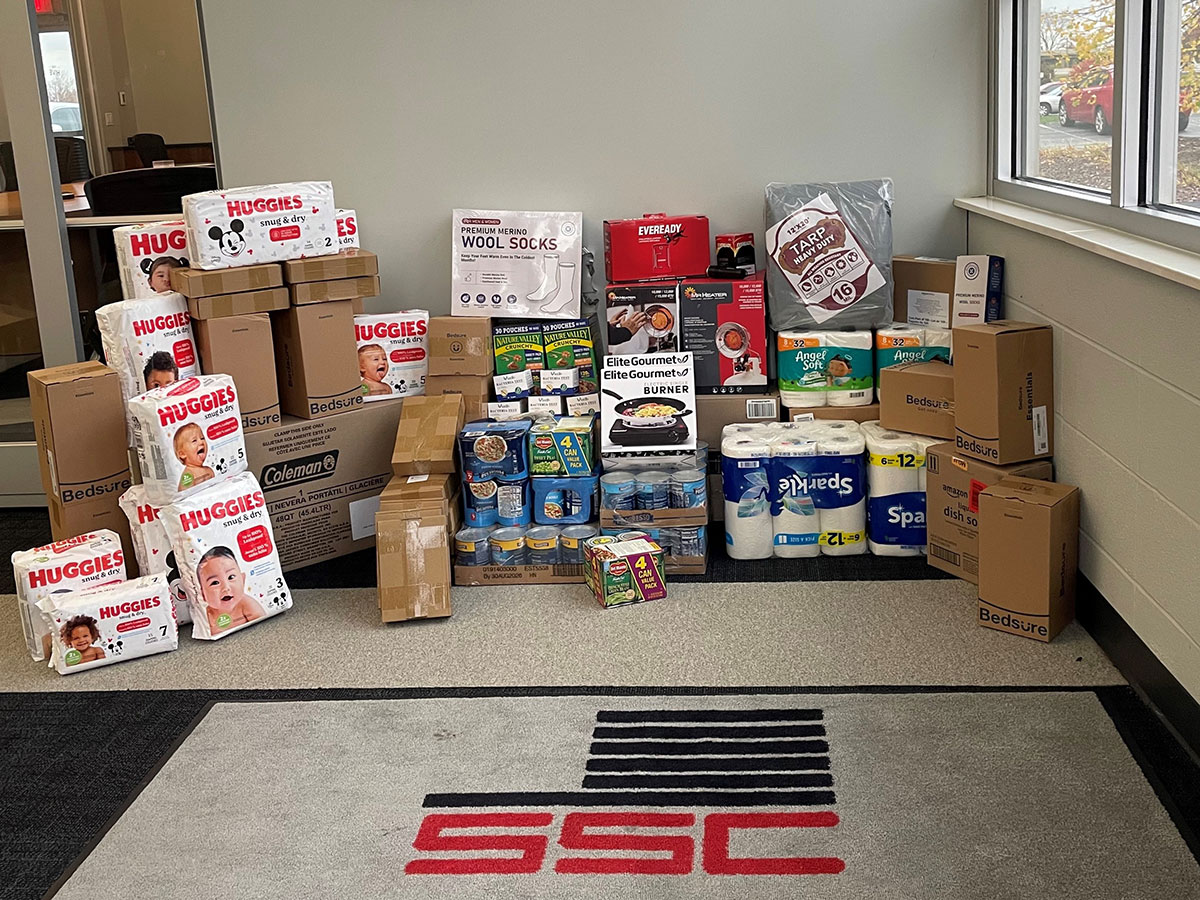 Boxes of soap, diapers, canned doog and other goods stacked in the corner at the SSC corporate office